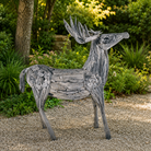Wooden deer sculpture in a garden setting